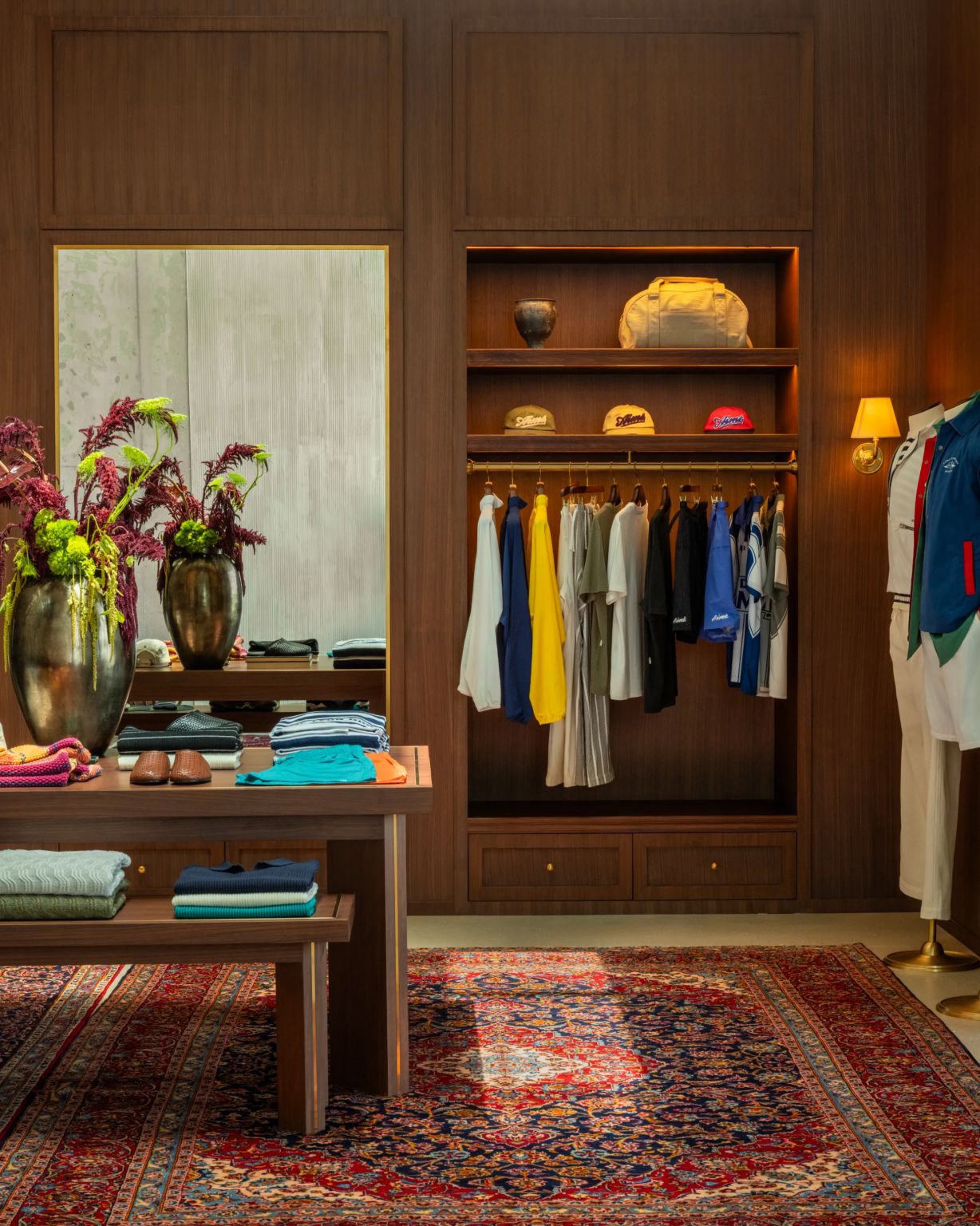 Colour-coordinated apparel and accessories presented in a walnut retail interior